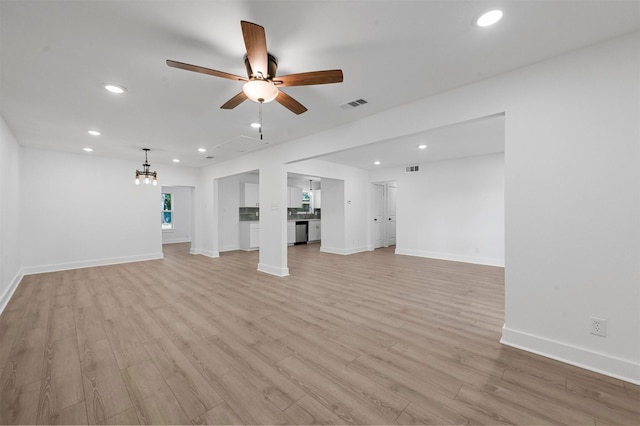 unfurnished living room featuring ceiling fan and light hardwood / wood-style flooring