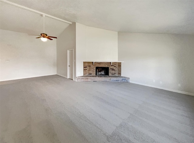 unfurnished living room with high vaulted ceiling, carpet, baseboards, a ceiling fan, and a fireplace