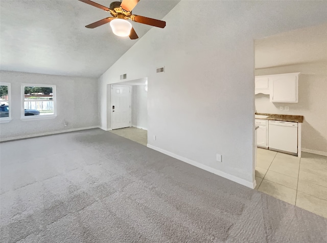 unfurnished living room with high vaulted ceiling, ceiling fan, light colored carpet, and a textured ceiling