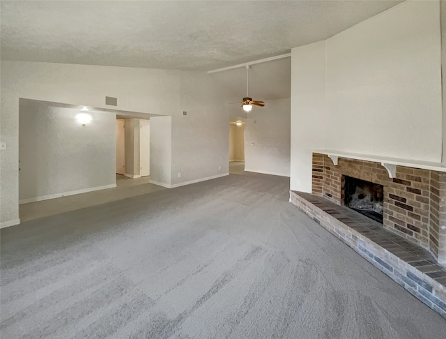 unfurnished living room featuring a textured ceiling, high vaulted ceiling, a brick fireplace, carpet, and ceiling fan