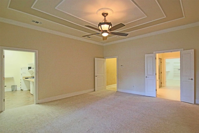 unfurnished bedroom featuring ornamental molding, ensuite bath, and light colored carpet