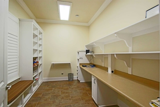 interior space with ornamental molding and built in desk