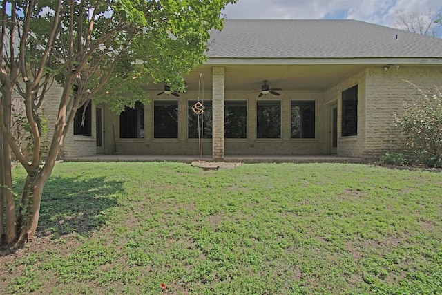 back of property featuring a lawn, ceiling fan, and a patio area