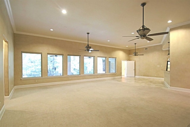 unfurnished living room with ornamental molding, ceiling fan, and light carpet