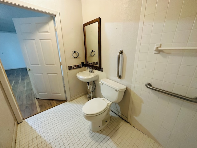 bathroom with tile patterned flooring, sink, and toilet