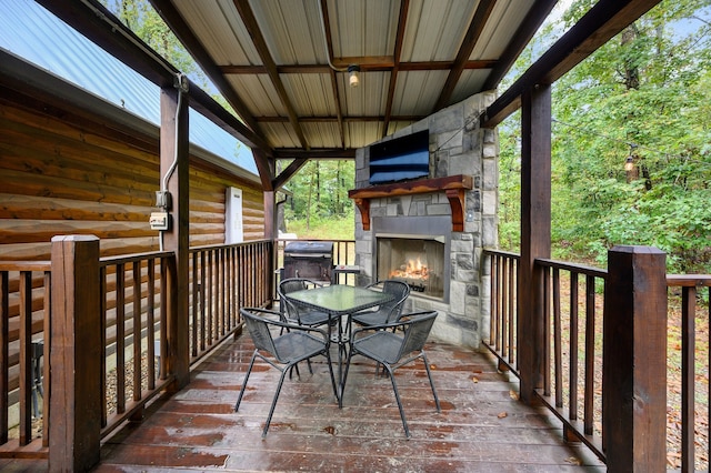 deck featuring an outdoor stone fireplace