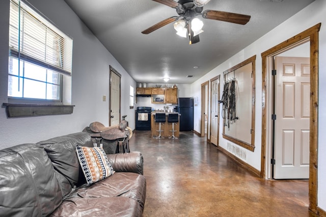 living room featuring a textured ceiling and ceiling fan