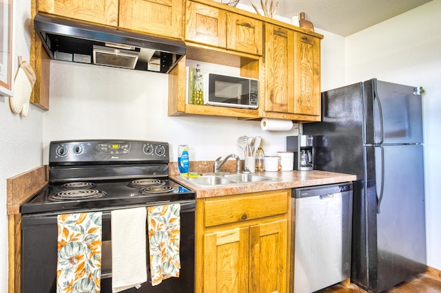 kitchen featuring range hood, wood-type flooring, black appliances, and sink