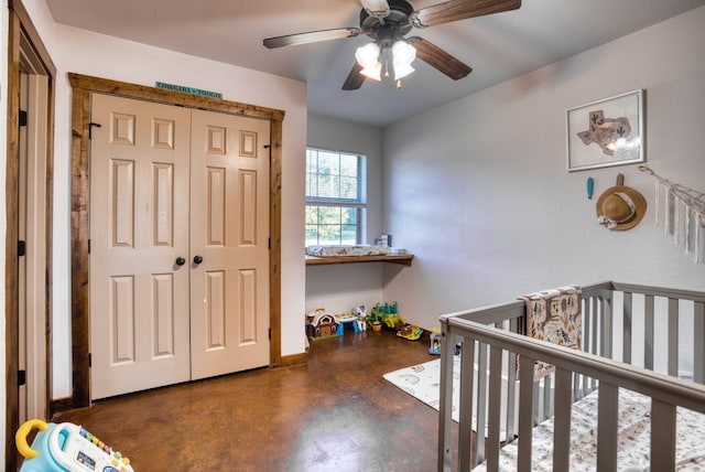 bedroom featuring ceiling fan, a nursery area, and a closet