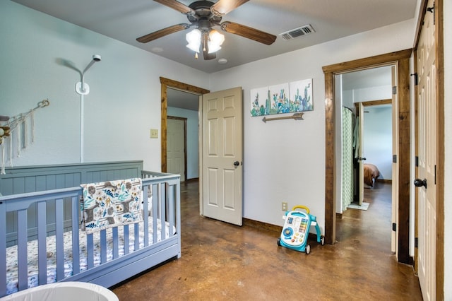 bedroom featuring ceiling fan and a nursery area