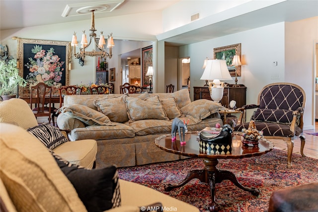 living room with wood-type flooring, a chandelier, and vaulted ceiling