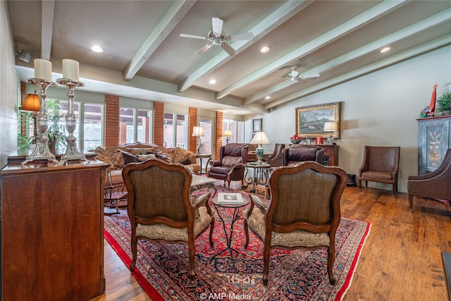 living room featuring wood-type flooring, vaulted ceiling with beams, and ceiling fan