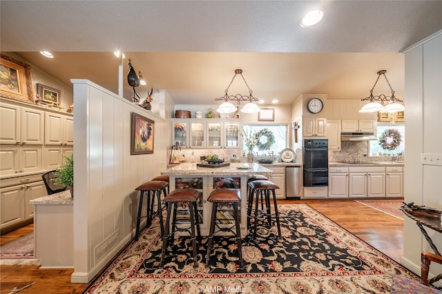 dining room featuring a textured ceiling and light hardwood / wood-style floors