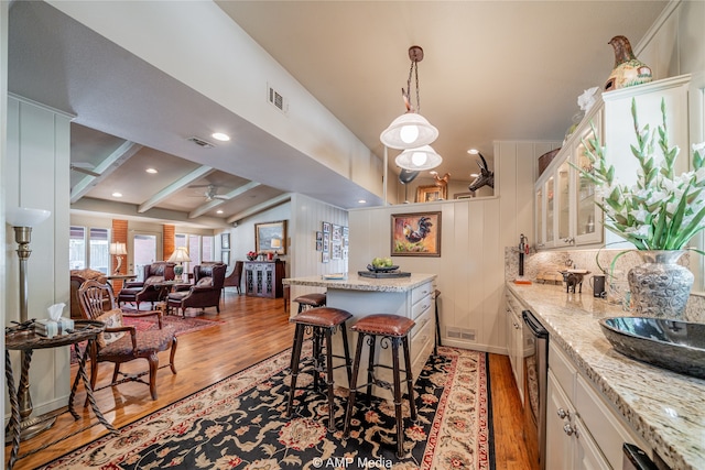 interior space with light wood-type flooring, lofted ceiling with beams, and ceiling fan