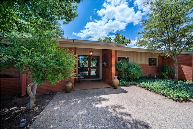 view of exterior entry featuring french doors