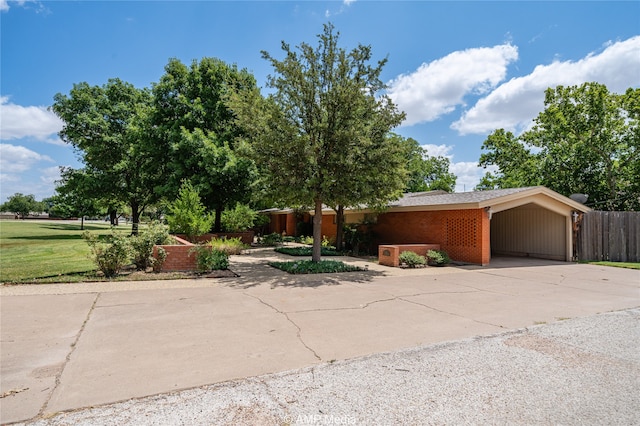 view of front of property with a front yard and a carport