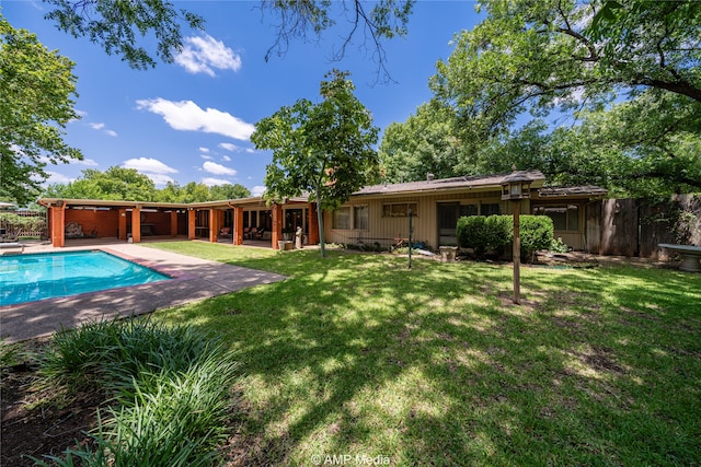 view of swimming pool with a patio area and a yard