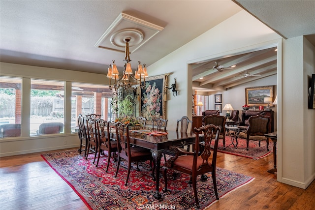 dining room featuring hardwood / wood-style flooring, ceiling fan with notable chandelier, and lofted ceiling with beams