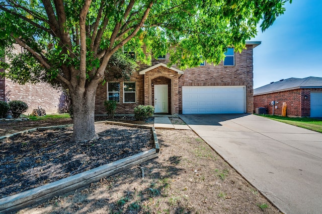 view of front of house featuring a garage and central AC