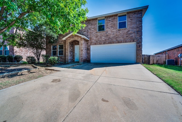 front of property featuring a garage and central air condition unit