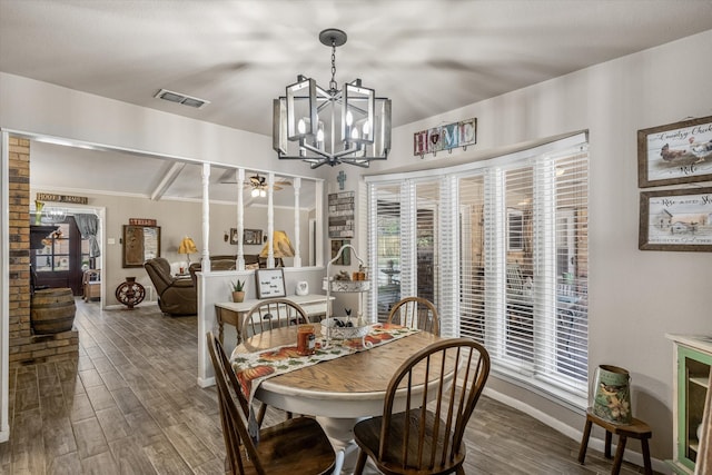 dining area featuring ceiling fan with notable chandelier and hardwood / wood-style floors