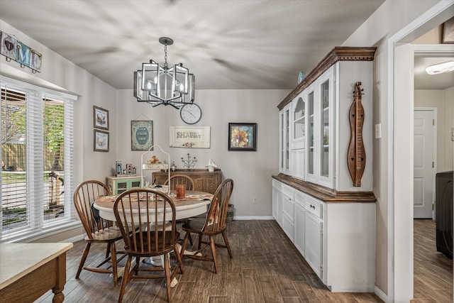 dining room featuring dark wood-type flooring and a notable chandelier