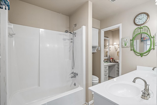 full bathroom featuring tub / shower combination, vanity, and toilet