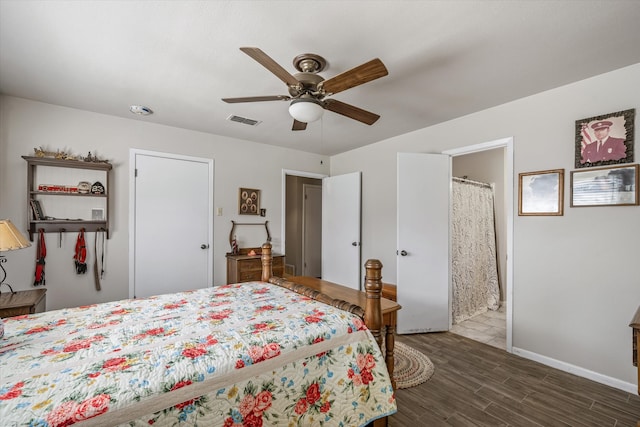 bedroom with connected bathroom, ceiling fan, and dark wood-type flooring