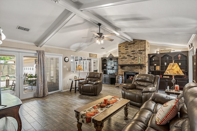 living room with a fireplace, crown molding, ceiling fan, hardwood / wood-style flooring, and vaulted ceiling with beams