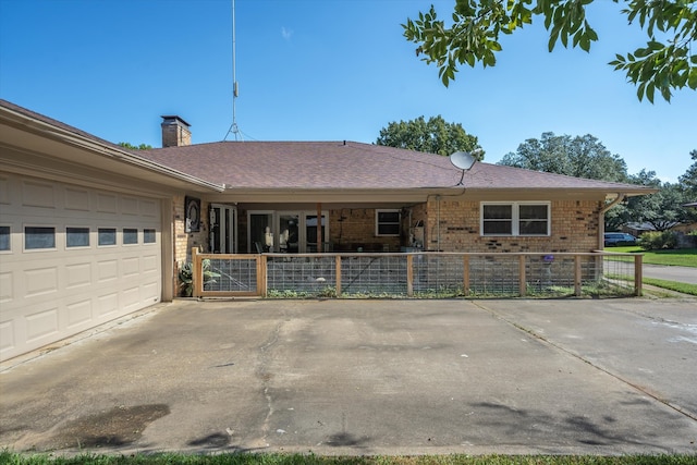 ranch-style home featuring a garage