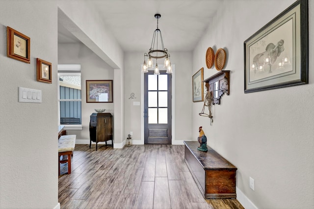 entryway featuring hardwood / wood-style flooring and a notable chandelier