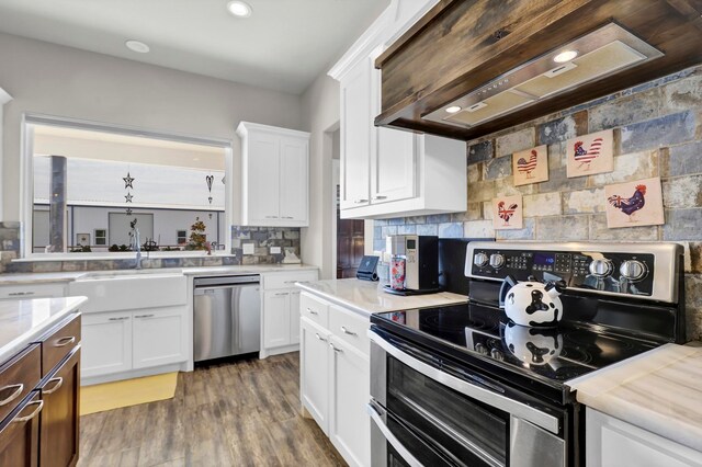 kitchen featuring white cabinets, appliances with stainless steel finishes, dark hardwood / wood-style floors, and custom range hood