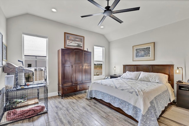 bedroom featuring lofted ceiling, ceiling fan, and light hardwood / wood-style flooring