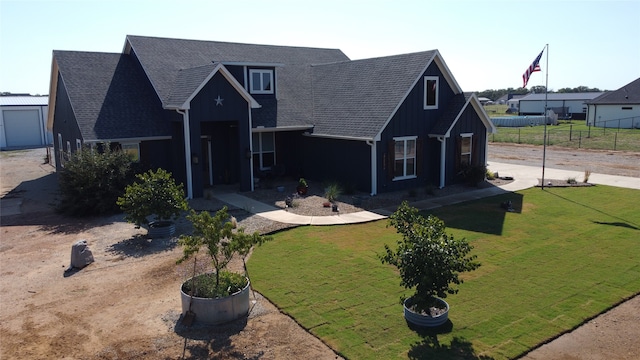 view of front of property featuring a garage and a front yard