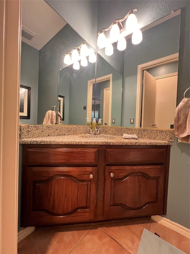 bathroom with tile patterned flooring and vanity