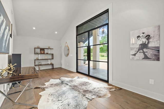 entryway with lofted ceiling and hardwood / wood-style flooring