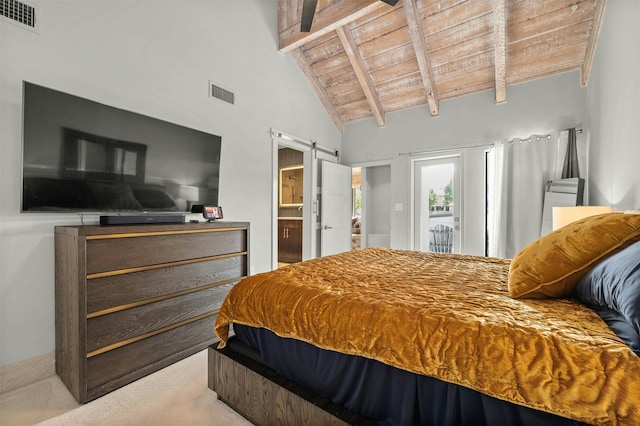 bedroom featuring wood ceiling, beam ceiling, light colored carpet, a barn door, and ensuite bath