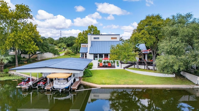 dock area with a lawn and a water view