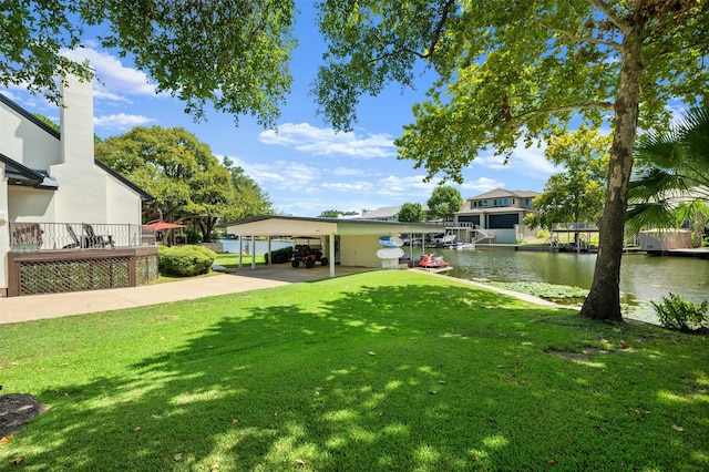 view of yard featuring a dock, a carport, and a deck with water view