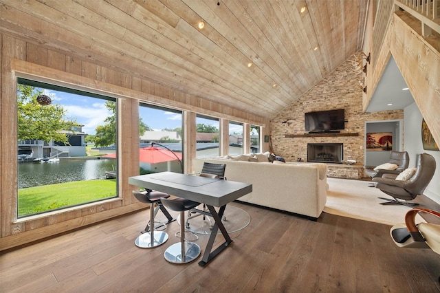 interior space with a large fireplace, a water view, hardwood / wood-style flooring, and wooden ceiling