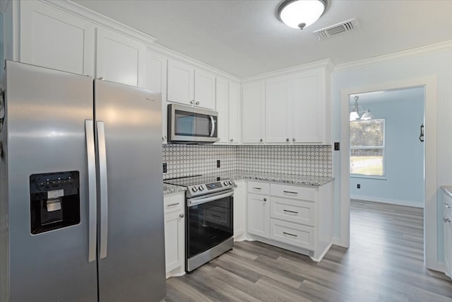 kitchen featuring light stone countertops, white cabinetry, appliances with stainless steel finishes, and light hardwood / wood-style flooring