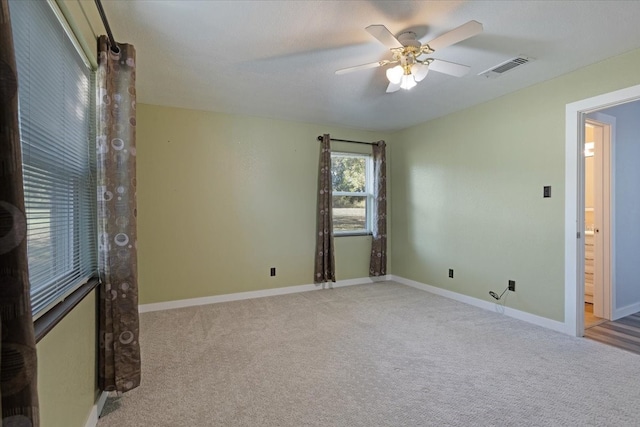 unfurnished room featuring light carpet and ceiling fan