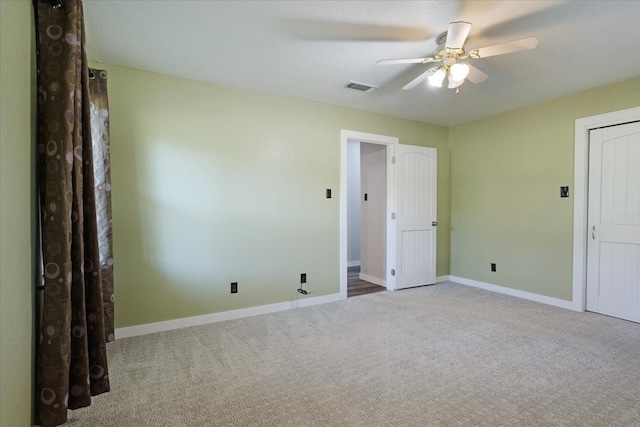 spare room with light carpet and ceiling fan