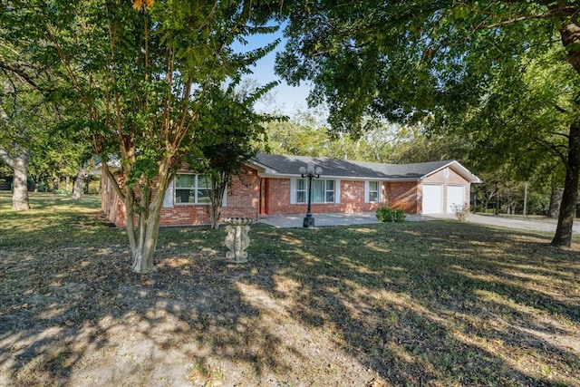 single story home featuring a garage and a front yard