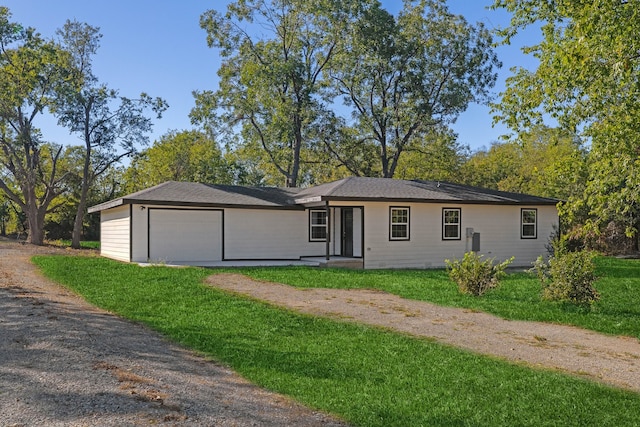 single story home featuring a garage and a front yard