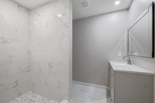 bathroom featuring vanity and tiled shower