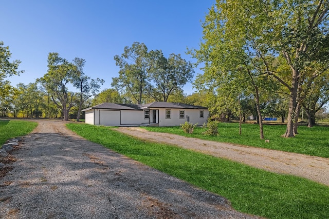 view of front of house featuring a garage and a front lawn