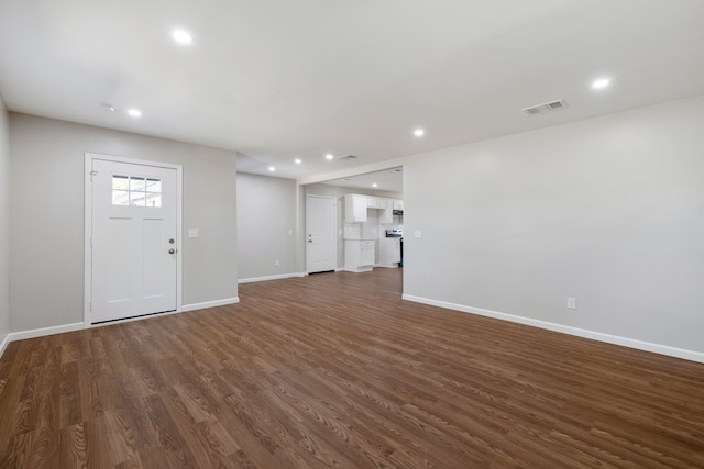 unfurnished living room with dark hardwood / wood-style flooring