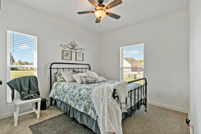 bedroom with ceiling fan and light colored carpet