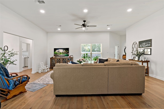 living room featuring ceiling fan and light hardwood / wood-style flooring